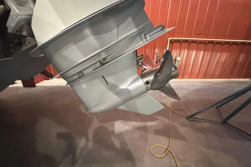 Slide: The Image of Close-up of a 2021 Axopar 28 Cabin boat propeller in a garage setting. - 25