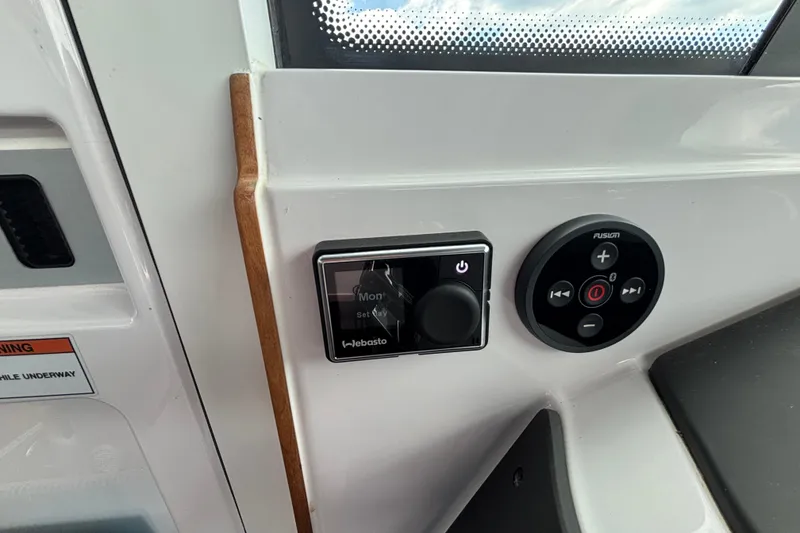 Slide: The Image of Control panel of a 2021 Axopar 28 Cabin boat featuring Webasto and Fusion systems. - 20