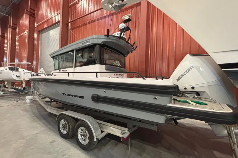 Slide: The Image of 2021 Axopar 28 Cabin boat on trailer in indoor storage facility. - 24