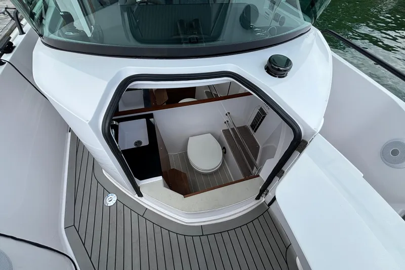 Slide: The Image of 2021 Axopar 28 Cabin boat interior with compact bathroom and modern design. - 17