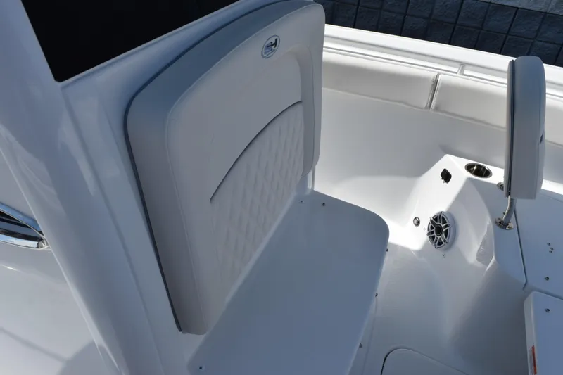 Slide: The Image of 2027 Sea Hunt Ultra 255 SE boat interior with cushioned seating and speaker. - 12