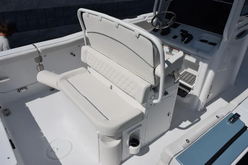Slide: The Image of 2027 Sea Hunt Ultra 255 SE boat interior with white seating and helm controls. - 7