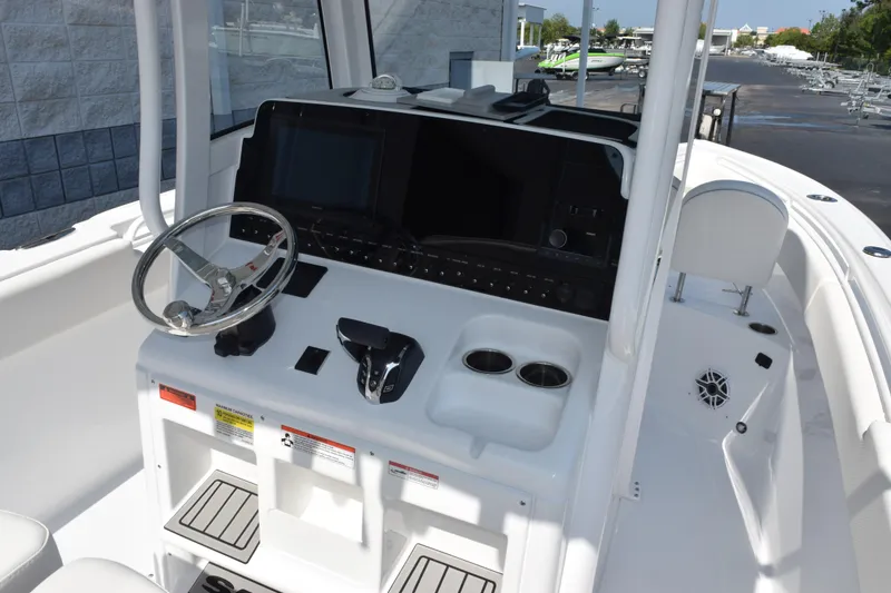 Slide: The Image of 2027 Sea Hunt Ultra 255 SE boat dashboard with steering wheel and controls. - 9