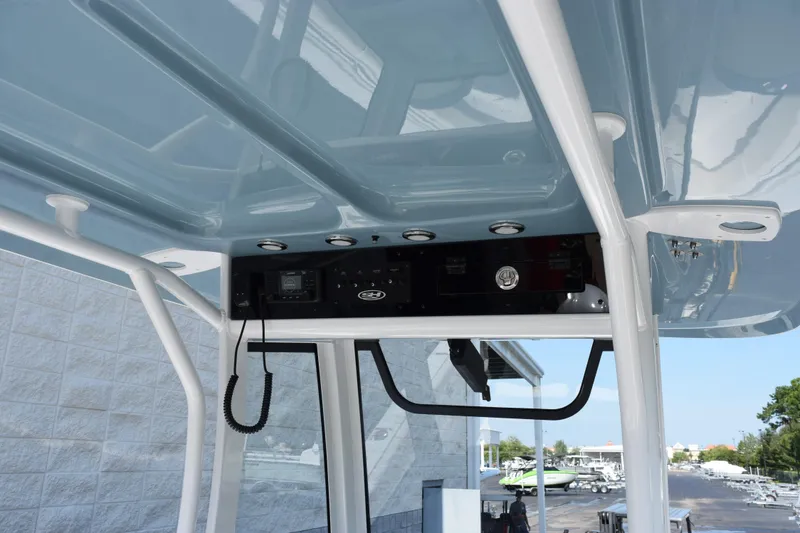 Slide: The Image of 2027 Sea Hunt Ultra 255 SE boat console with electronics and overhead structure. - 10