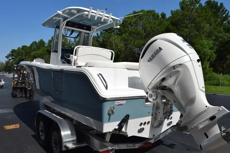 Slide: The Image of 2027 Sea Hunt Ultra 255 SE boat with Yamaha engine on trailer, parked outdoors. - 6