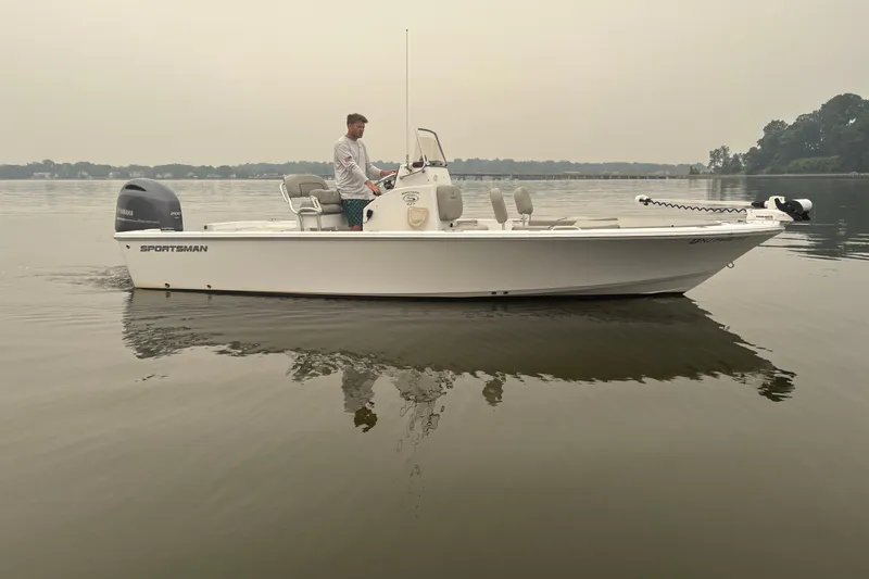 Slide: The Image of 2023 Sportsman Masters 227 Bay Boat on calm water, side view. - 1