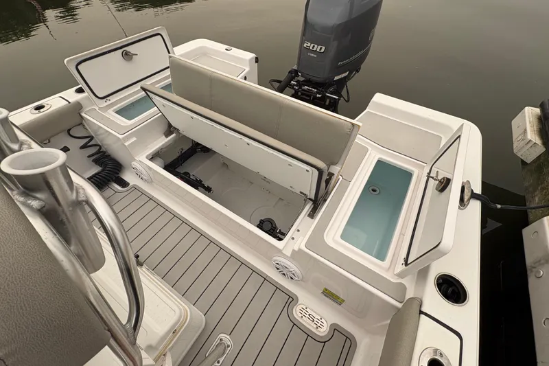 Slide: The Image of 2023 Sportsman Masters 227 Bay Boat with open storage compartments and Yamaha outboard motor. - 16