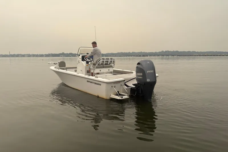 Slide: The Image of 2023 Sportsman Masters 227 Bay Boat on calm water with Yamaha engine. - 4