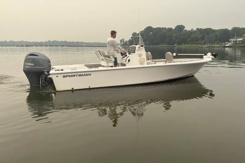 Slide: The Image of 2023 Sportsman Masters 227 Bay Boat on calm water with Yamaha engine. - 2