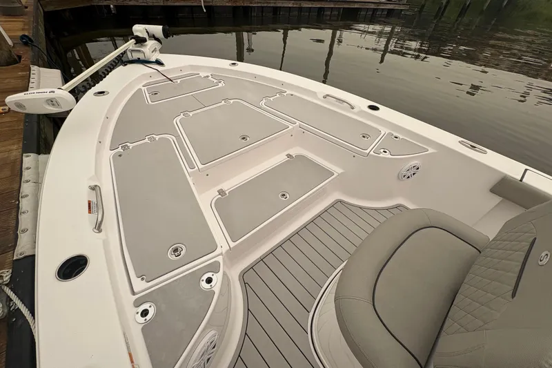 Slide: The Image of 2023 Sportsman Masters 227 Bay Boat deck with storage compartments and seating. - 10