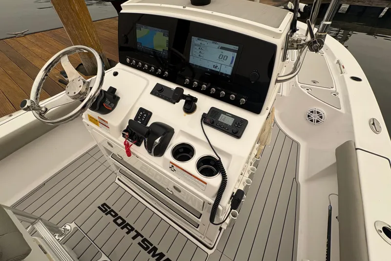 Slide: The Image of 2023 Sportsman Masters 227 Bay Boat console with steering wheel and navigation displays. - 7