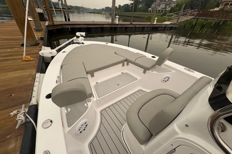 Slide: The Image of 2023 Sportsman Masters 227 Bay Boat docked, featuring spacious seating and sleek design. - 8