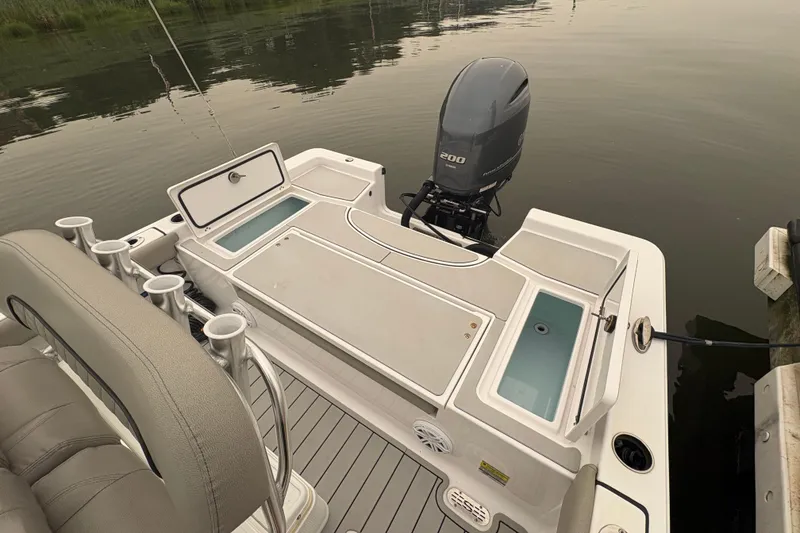 Slide: The Image of 2023 Sportsman Masters 227 Bay Boat with Yamaha engine, featuring spacious deck and storage compartments. - 14