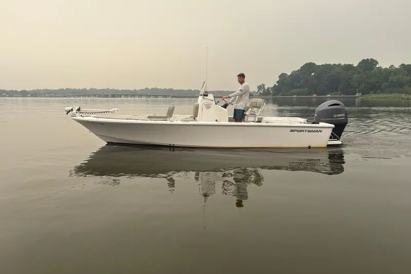 Slide: The Image of 2023 Sportsman Masters 227 Bay Boat on calm water, with driver, overcast sky. - 3