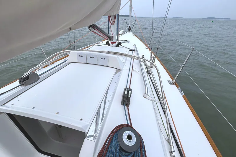Slide: The Image of The deck of a 2006 J/100 with sleek lines and sailing equipment. - 21