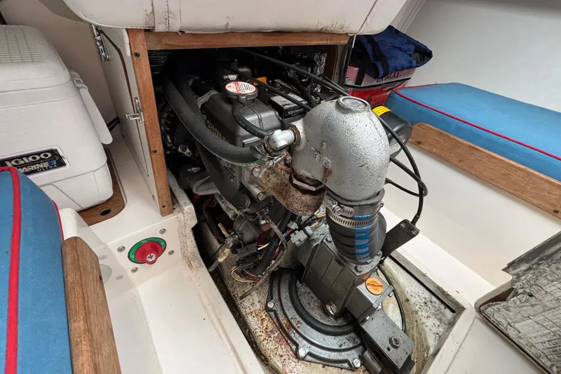 Slide: The Image of Engine compartment of a 2006 J Boats J/100 sailboat, showcasing mechanical components and seating area. - 38