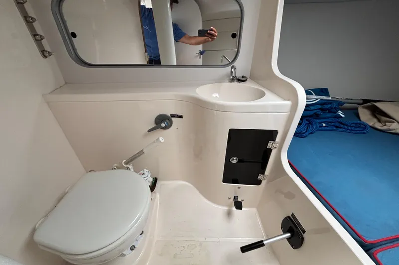 Slide: The Image of Compact bathroom in 2006 J Boats J/100 sailboat, featuring toilet, sink, and storage. - 31
