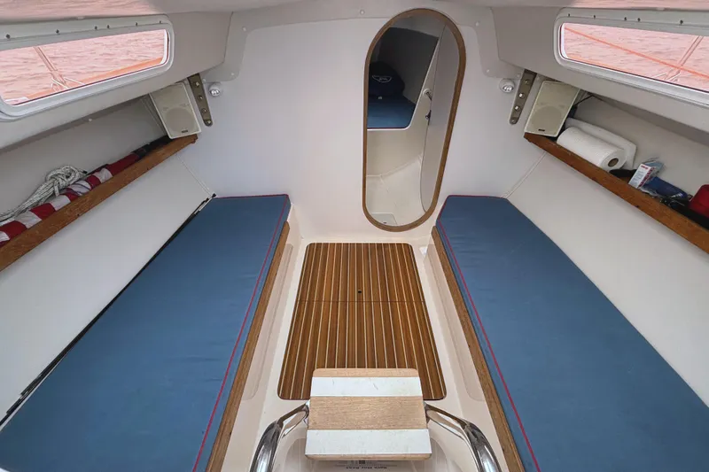 Slide: The Image of Interior of 2006 J Boats J/100 sailboat with blue cushions and wooden flooring. - 24