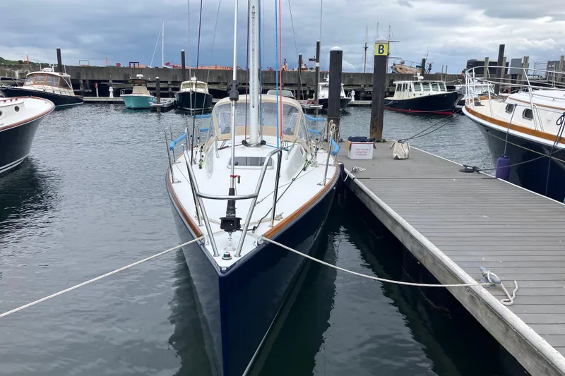 Slide: The Image of 2006 J Boats J/100 sailboat docked at marina, overcast sky. - 4