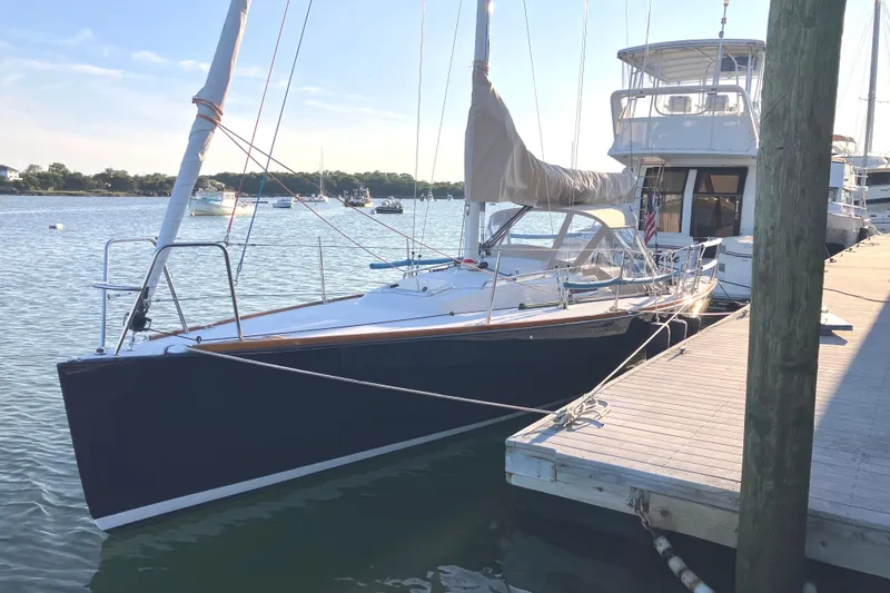 Slide: The Image of 2006 J Boats J/100 sailboat docked in a serene marina setting. - 3