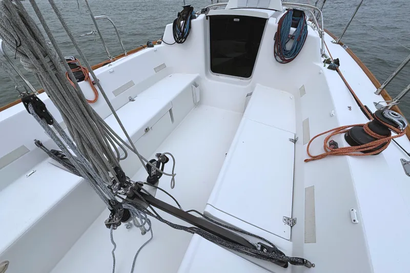 Slide: The Image of The image shows the cockpit of a 2006 J/100 sailboat with a clean, white deck. - 15