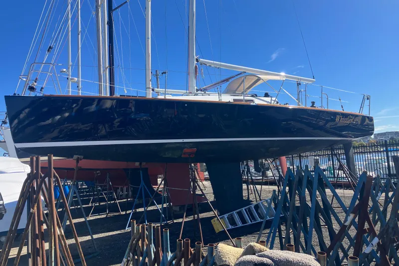 Slide: The Image of 2006 J Boats J/100 sailboat on dry dock, blue hull, sunny day. - 5