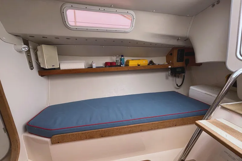 Slide: The Image of Interior cabin of a 2006 J Boats J/100 sailboat with a blue cushioned berth. - 27