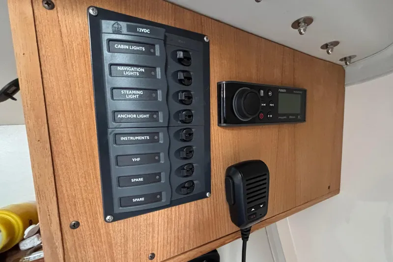 Slide: The Image of Control panel on 2006 J Boats J/100 sailboat with switches and radio equipment. - 32