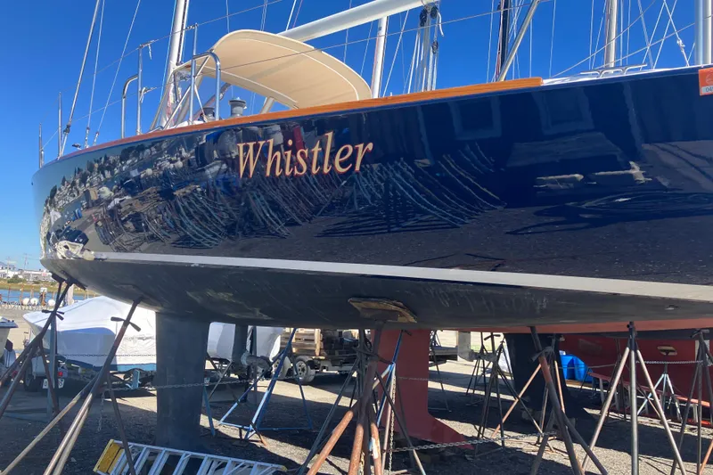 Slide: The Image of 2006 J Boats J/100 sailboat "Whistler" on stands, reflecting marina surroundings. - 7