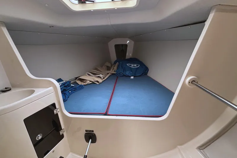 Slide: The Image of Interior cabin of a 2006 J Boats J/100 sailboat, featuring a cozy sleeping area. - 30