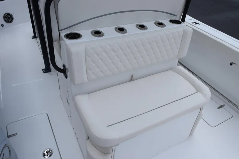 Slide: The Image of 2027 Sea Hunt Ultra 275 SE boat seating with cup holders and white upholstery. - 7