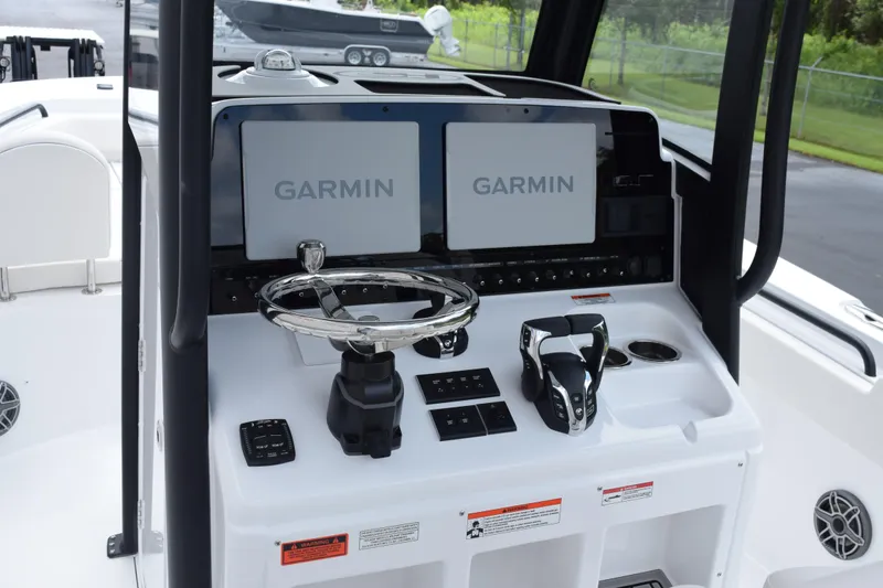 Slide: The Image of Helm of 2027 Sea Hunt Ultra 275 SE with Garmin displays and controls. - 8