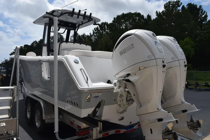 Slide: The Image of 2027 Sea Hunt Ultra 275 SE boat with dual outboard engines on a trailer. - 5
