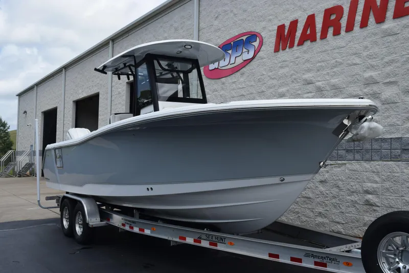 Slide: The Image of 2027 Sea Hunt Ultra 275 SE boat on trailer outside marine dealership. - 2