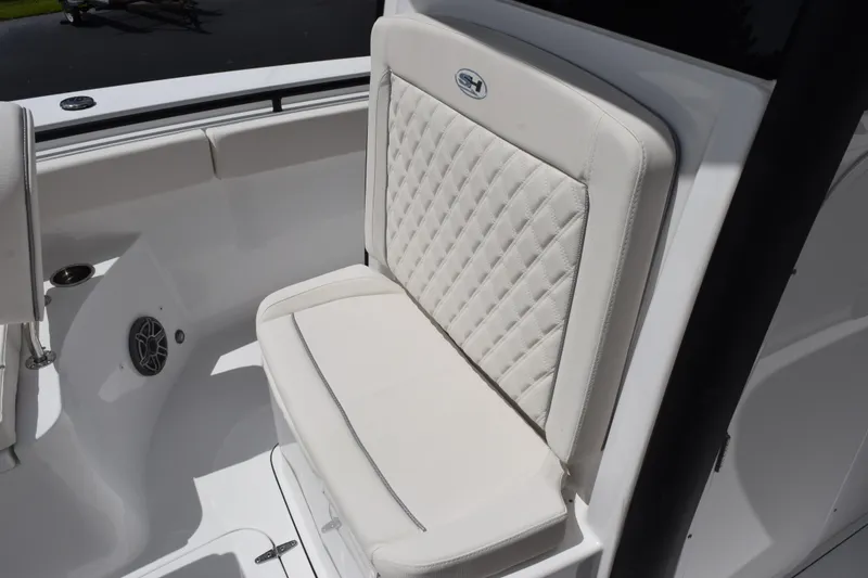 Slide: The Image of 2027 Sea Hunt Ultra 275 SE boat seat with quilted white upholstery. - 12