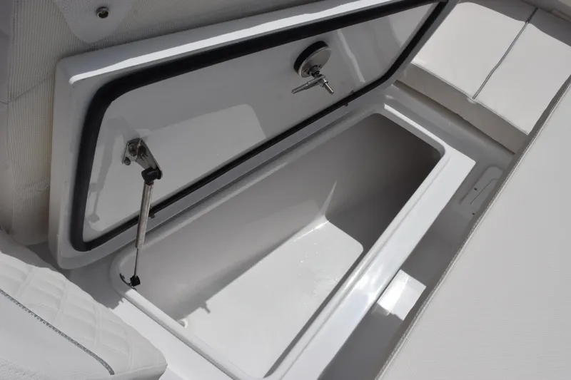 Slide: The Image of Storage compartment on a 2027 Sea Hunt Ultra 275 SE boat, open and empty. - 17