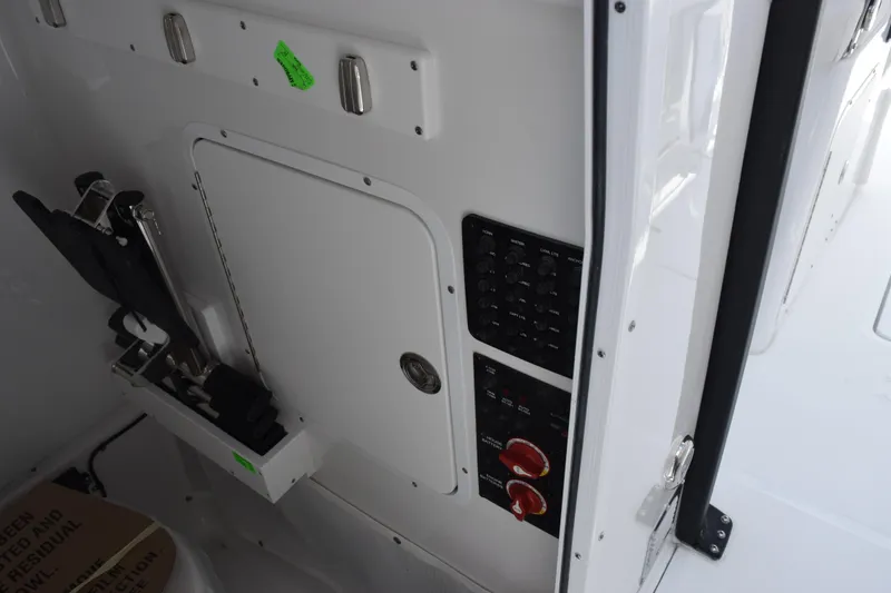 Slide: The Image of Control panel and storage compartment on 2027 Sea Hunt Ultra 275 SE boat. - 16