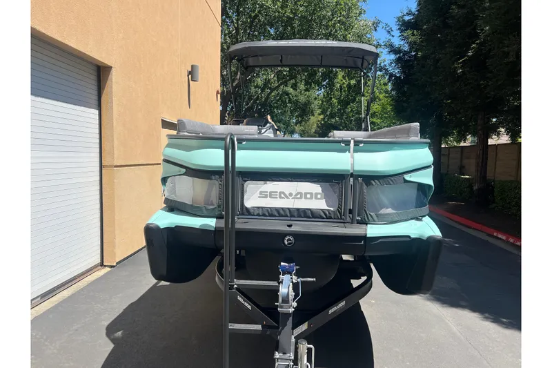 Slide: The Image of 2026 Sea-Doo Switch Cruise 21 boat on trailer, parked outdoors. - 2