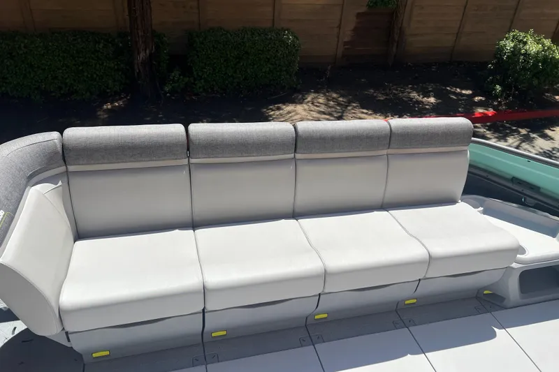 Slide: The Image of 2026 Sea-Doo Switch Cruise 21 boat seating, featuring gray cushioned bench in outdoor setting. - 12