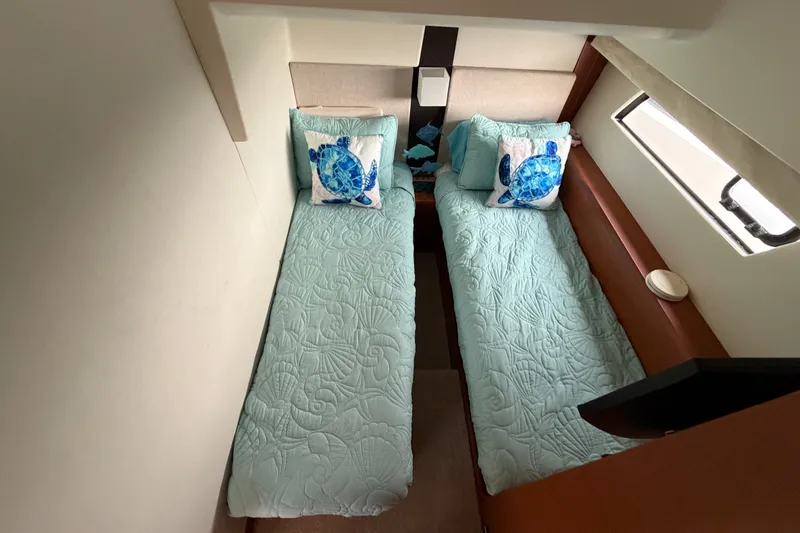 Slide: The Image of Twin beds with sea-themed decor in a 2012 Prestige 500S yacht cabin. - 40