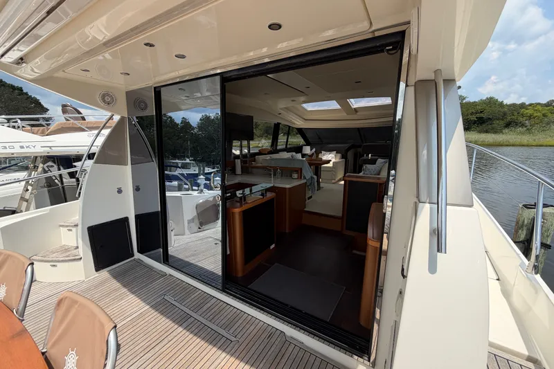 Slide: The Image of Luxurious 2012 Prestige 500S yacht interior with open sliding doors, showcasing elegant design. - 10