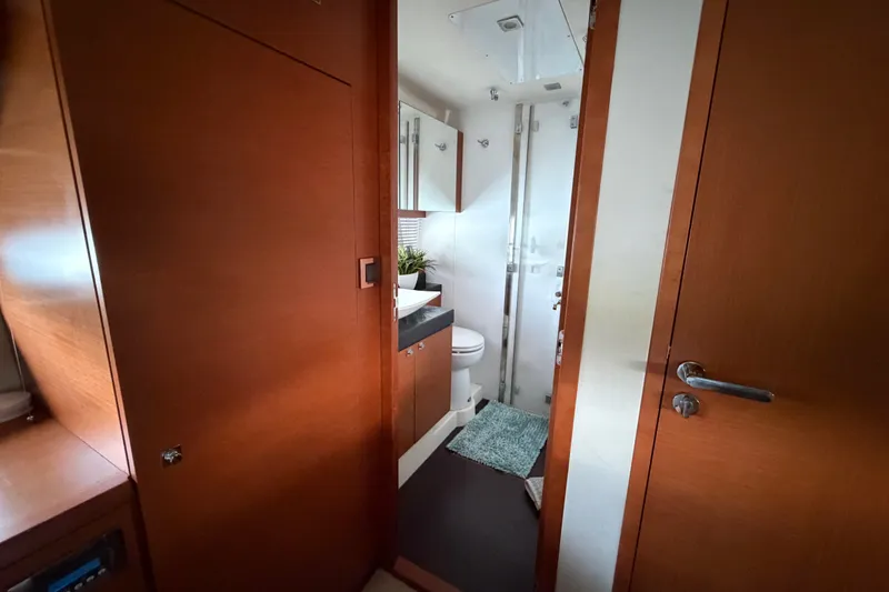 Slide: The Image of Interior view of a 2012 Prestige 500S yacht bathroom with wooden finishes and modern fixtures. - 31