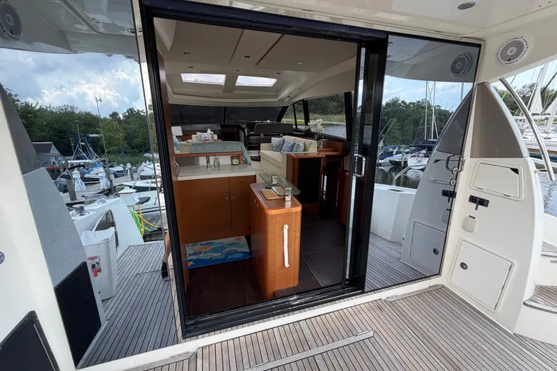 Slide: The Image of Interior view of a 2012 Prestige 500S yacht, showcasing modern design and marina backdrop. - 79