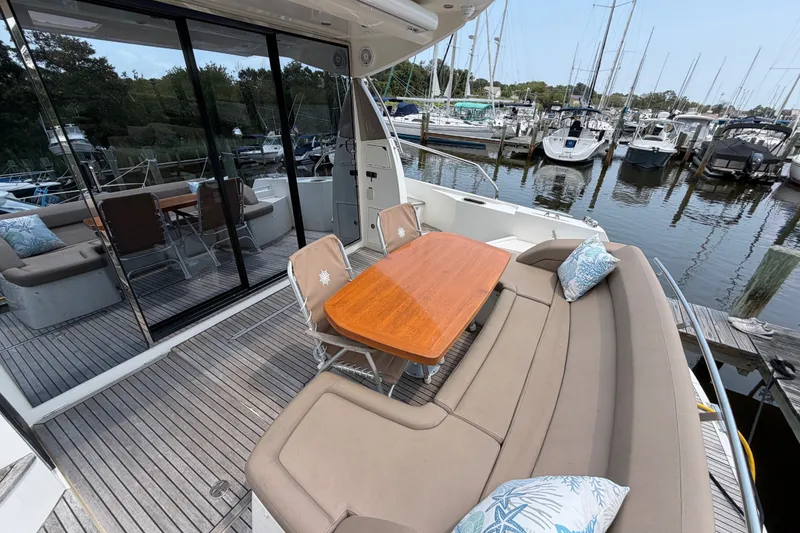 Slide: The Image of Prestige 500S 2012 yacht with elegant outdoor seating and marina view. - 6