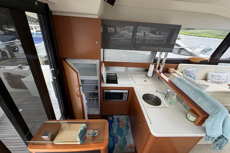 Slide: The Image of Luxurious 2012 Prestige 500S yacht interior with modern kitchen and cozy seating area. - 15