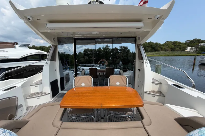 Slide: The Image of Luxury 2012 Prestige 500S yacht with outdoor seating and scenic marina view. - 8