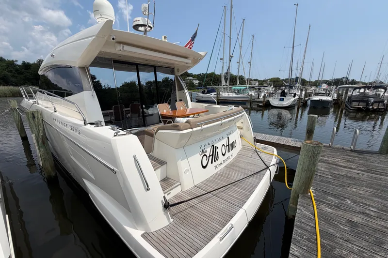 Slide: The Image of Luxury 2012 Prestige 500S yacht docked at marina, featuring elegant design and spacious deck. - 3