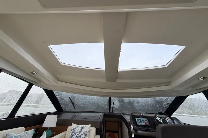 Slide: The Image of Interior view of 2012 Prestige 500S yacht cockpit with skylight and modern controls. - 67