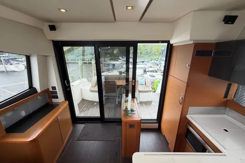 Slide: The Image of Interior view of 2012 Prestige 500S yacht with modern kitchen and sliding glass doors. - 83
