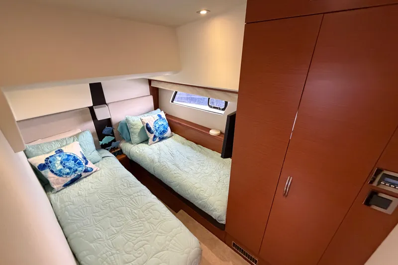 Slide: The Image of Luxurious twin cabin in 2012 Prestige 500S yacht with sea-themed decor. - 48